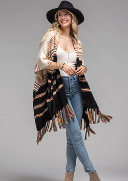 Stay snug and stylish in this plush faux fur ruana! Crafted with a striped pattern and finished with a chic fringe, this ruana will keep you cozy and make you look oh-so-cool. The soft eyelash accent gives it a delightful touch.   *100% Acrylic  *APPROX. L 27.5