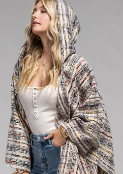 Stay comfy and snazzy with this plaid hooded ruana! Its hood and pockets let you bundle up comfortably and its stylish appeal will have you looking your best while keeping cozy. And at 51