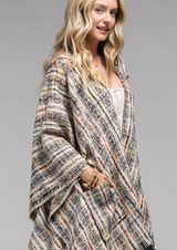 Stay comfy and snazzy with this plaid hooded ruana! Its hood and pockets let you bundle up comfortably and its stylish appeal will have you looking your best while keeping cozy. And at 51"x59", it's big enough to cuddle up with a loved one too!  100% Polyester