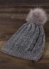 Stay warm (and stylish!) in this luxe chenille cable knit beanie! With its soft faux-fur pom-pom accent, this beanie is the perfect way to stay cozy this winter!  Keep the cold out and your cool in with this beanie - wooly bliss for your noggin!