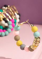 These Pastel Clay Bead Hoop Earrings are sure to turn some heads! Show off your chic charm with the stunning clay beaded hoops and accented metal disc beads; you'll be the center of attention! Plus, with a Nickel/Lead compliant design, you can keep your conscience clear. Stylish and sustainable - what more could you want?