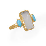 This druzy ring is a dream! 14 karat gold plated sterling silver ring features striking druzy and synthetic turquoise. Druzy measures 14.3mm x 7.3mm and turquoise is 5.9mm x 3.2mm. Band is 2mm wide. Available in whole sizes 6-9.  .925 Sterling Silver 